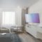 Sala moderna con televisor en pared, sillón, mueble blanco y ventana con cortinas, diseño minimalista.