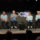 Personas en panel de discusión en conferencia tecnológica con fondo de logotipo WWDC, cuatro hombres sentados hablando.