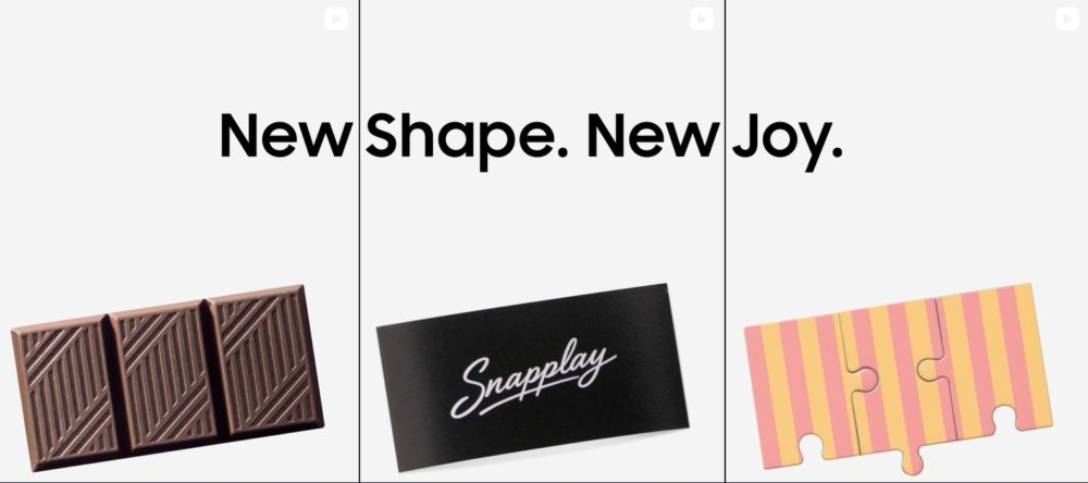 El Galaxy Z Fold8 se deja ver en nuevos teasers con una pista muy clara Chocolate con diseño nuevo y etiqueta Snapplay. Texto: New Shape. New Joy. junto a un diseño de puzzle.