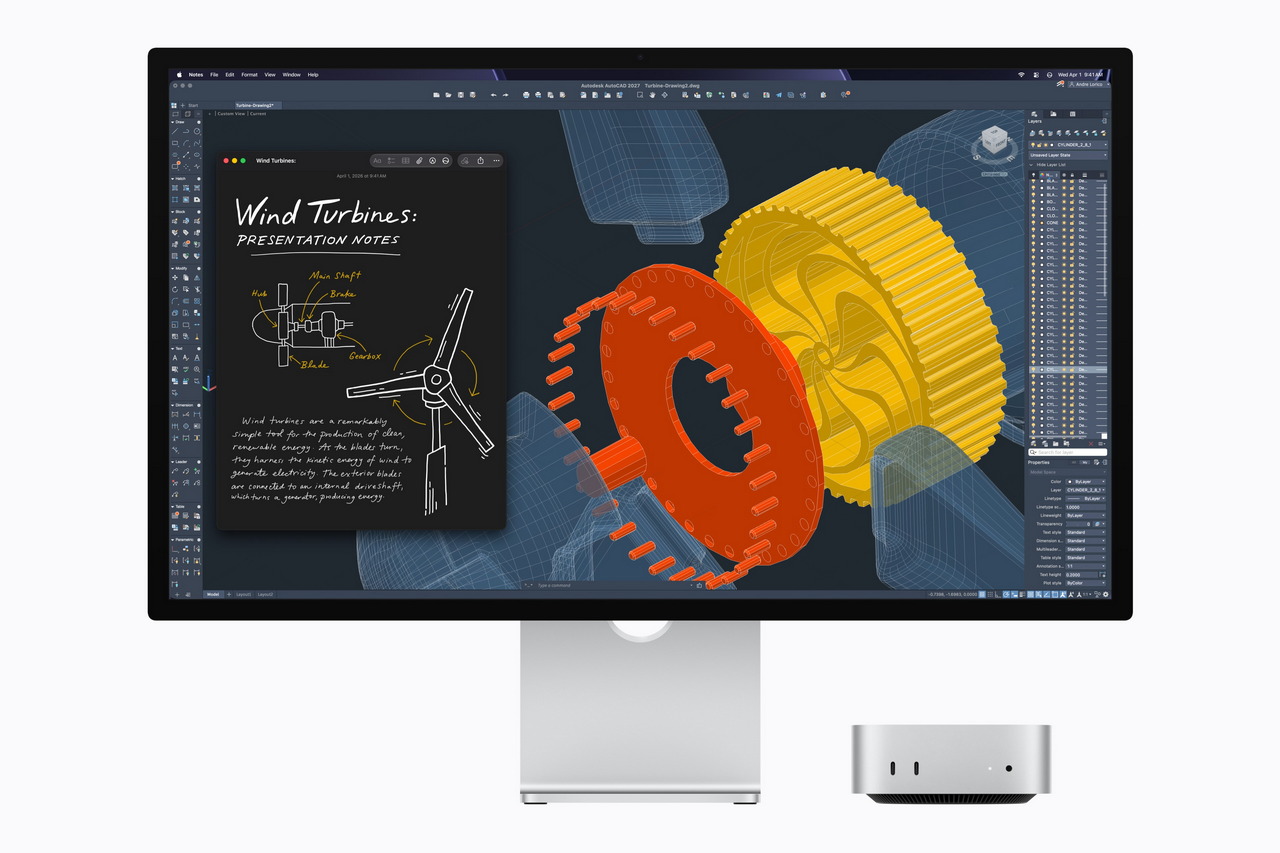 Monitor con diseño 3D de turbina eólica y notas de presentación, junto a un ordenador compacto.