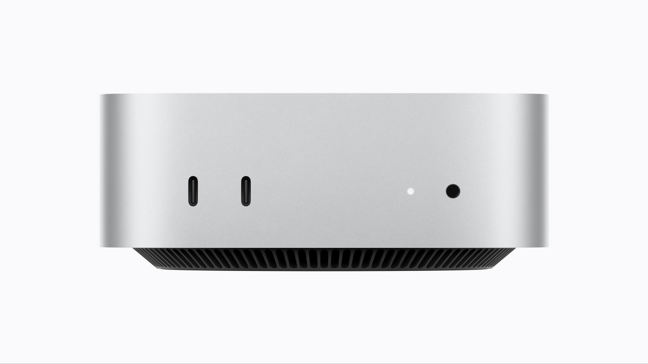 Computadora compacta plateada con puertos USB-C y diseño minimalista frontal. Ideal para escritorios pequeños.
