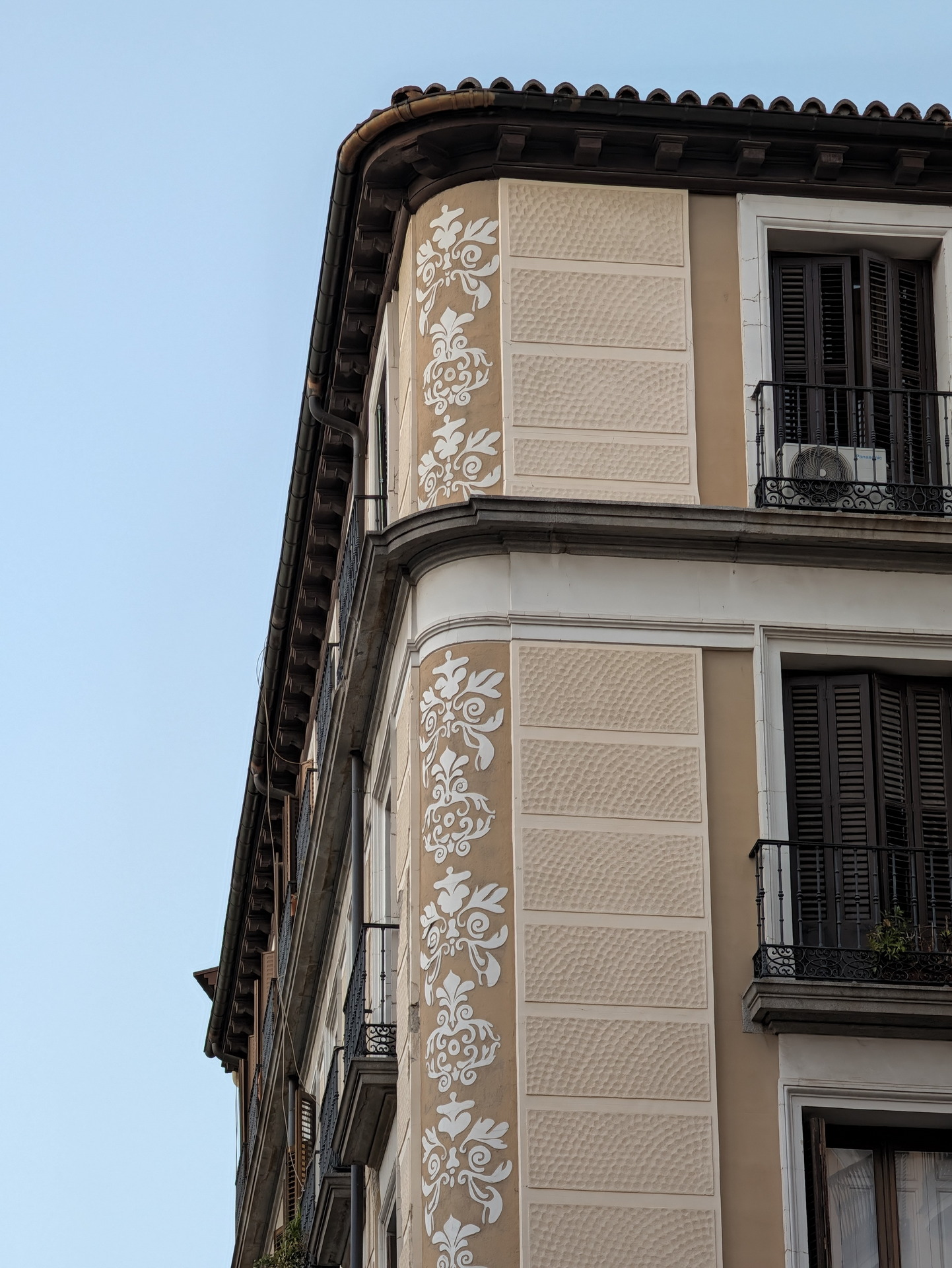 Fachada de edificio con diseño ornamental en el centro de la ciudad, mostrando detalles arquitectónicos clásicos.