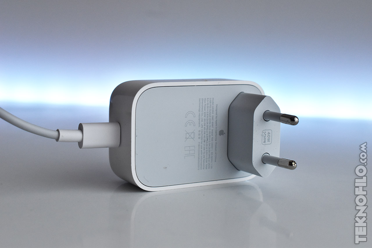 Cargador de pared USB blanco con enchufe europeo, fondo difuminado. Ideal para dispositivos electrónicos.