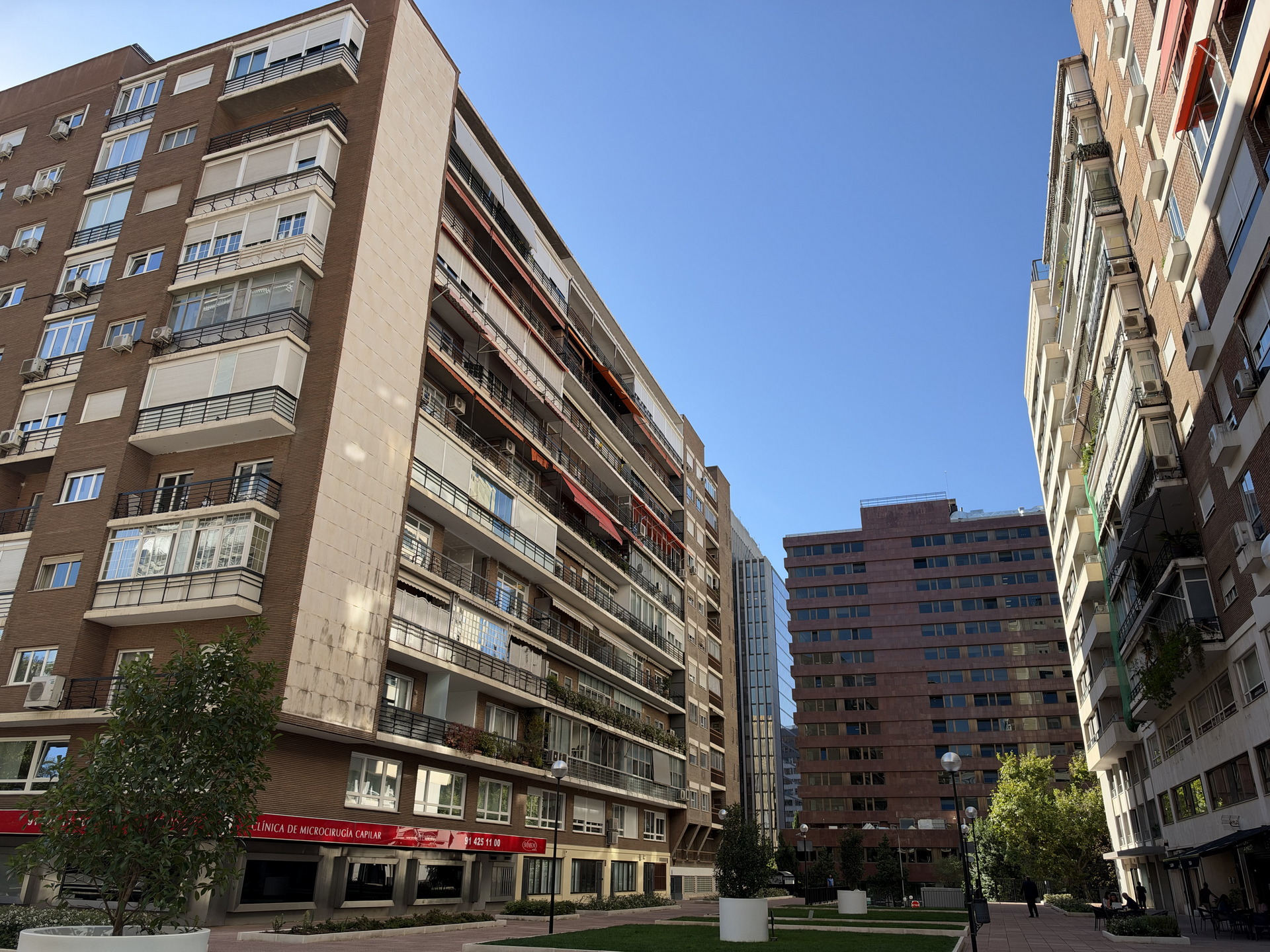 Edificios residenciales en un día soleado en una calle urbana con cielo azul.
