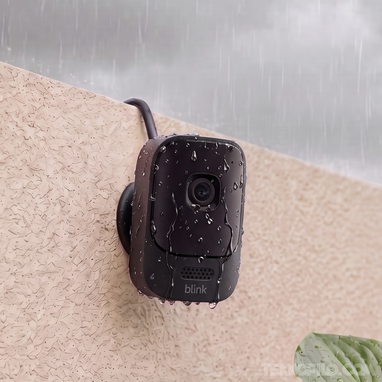 Blink Mini 4K+ instalada en una pared exterior bajo la lluvia